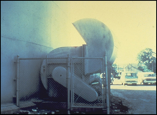 After a neighbor complained about the noise generated by this backward-inclined fan, which exhausted fumes from a tank at a rate of 50,000 cu ft (3,750 lb) per minute, the owner sought to redirect the noise by reversing the flow of air so that the air came back toward the fan. It was a self-defeating proposition: The air turbulence caused by the 180-degree turn at the outlet and the speed at which the fan had to run to overcome the system effect actually increased the noise.