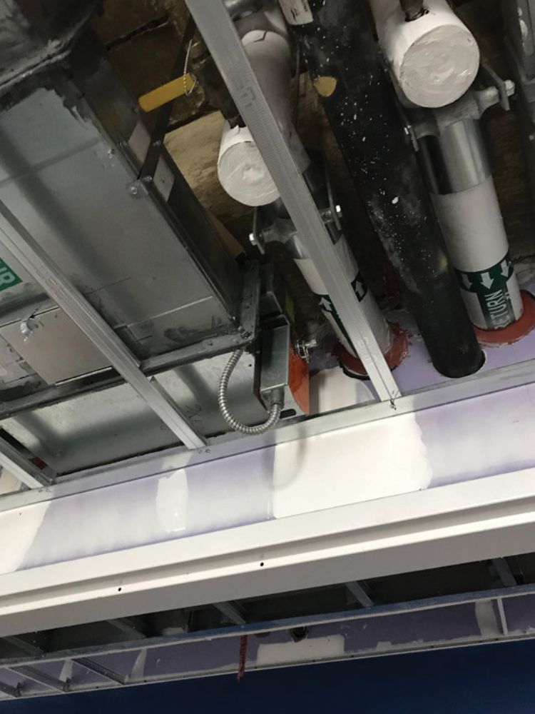 Photo A. Smoke damper installed with actuator below the ceiling line. The sleeve was extended and the damper was relocated to clear the ceiling line.