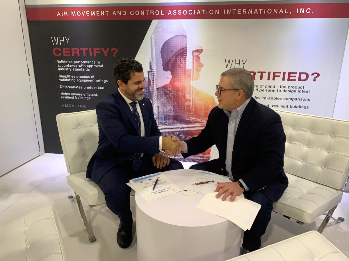 Raul Corredera Haener, president of Eurovent, (left) and Jim Meats, chairman of the board, AMCA, shake hands after signing the memorandum of understanding between the two associations.