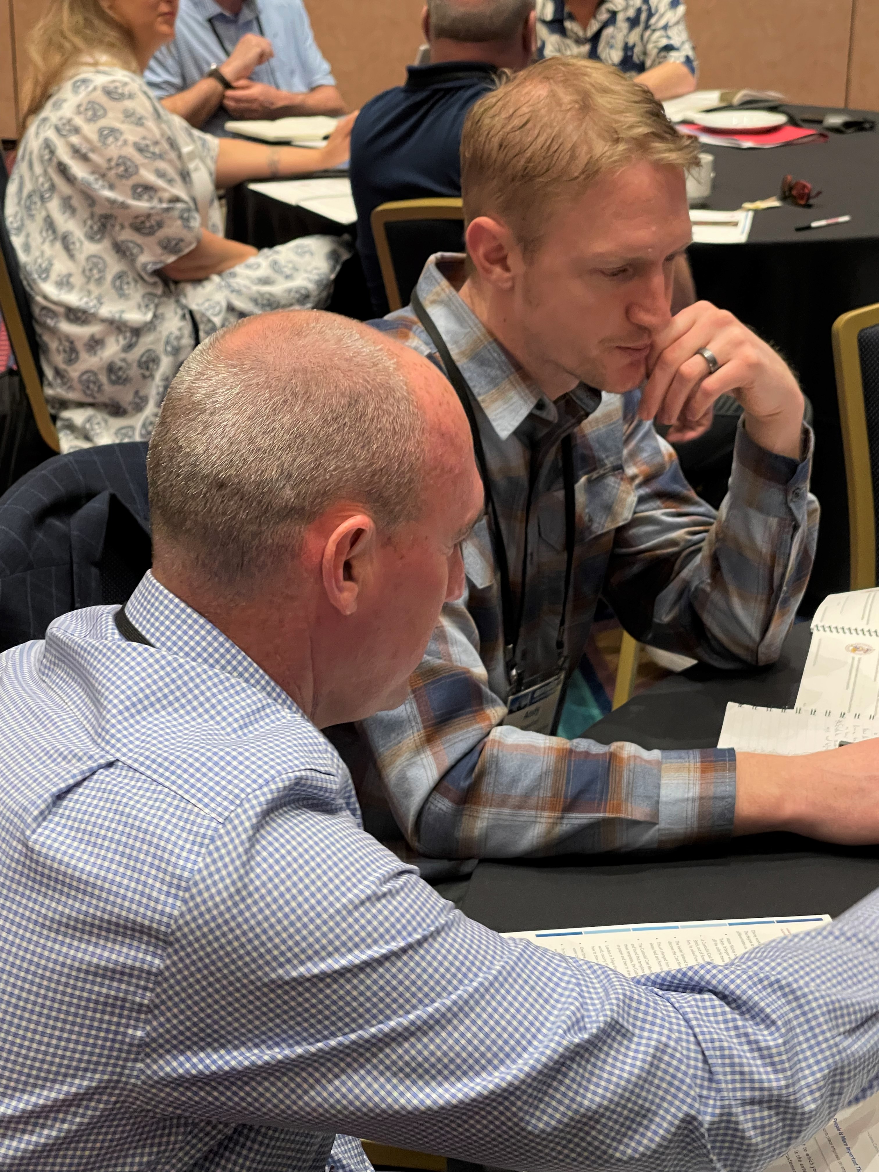 Nathan Redman, vice president of sales, Kinetics Noise Control Inc., (left) and Andy Bosscher, regional sales manager, Twin City Fan & Blower, take part in a small-group discussion during one of the keynote sessions the morning of March 3.
